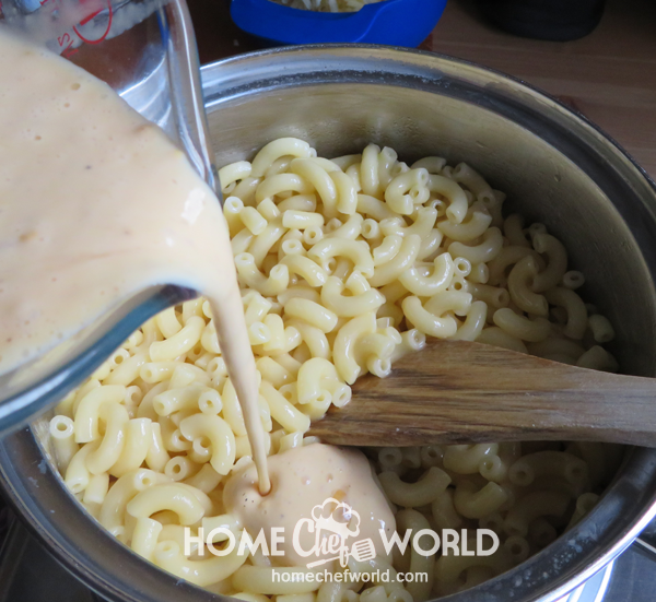 Pouring on Sauce Ingredients to Hot Macaroni over Burner